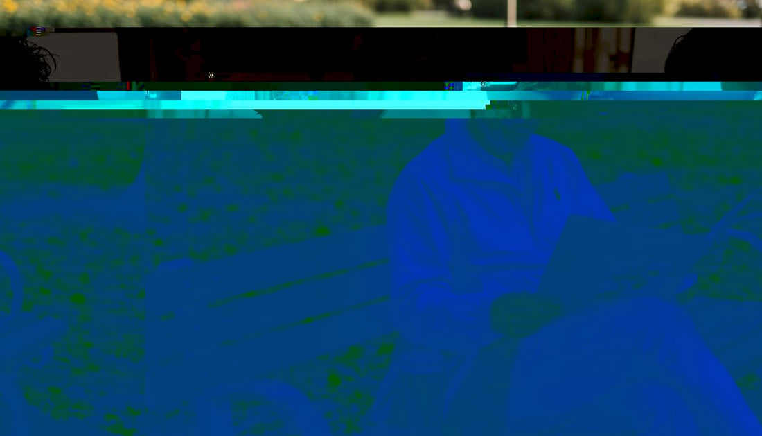 Man wearing premium cap reading on park bench