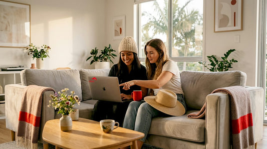 Friends browsing and comparing hats online at home