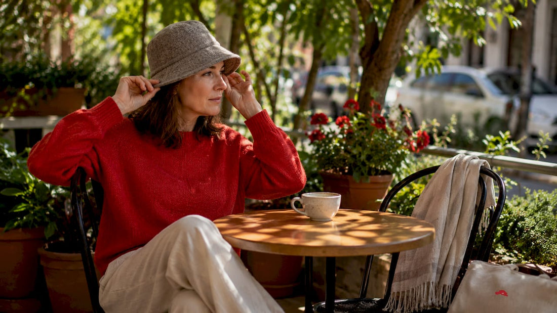 Person outdoors trying on wool bucket hat alternative