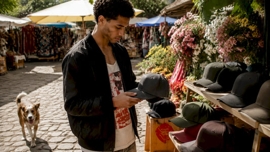 Person examining flexfit hats in urban shop