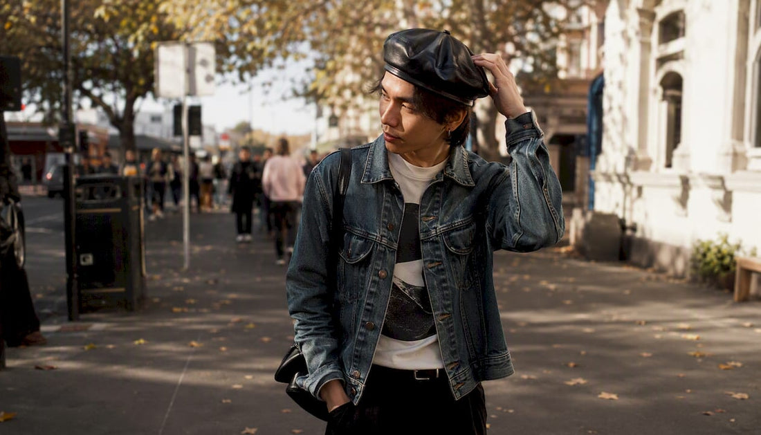 Person styling structured leather beret outdoors