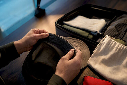 Traveller checking hat dryness before packing