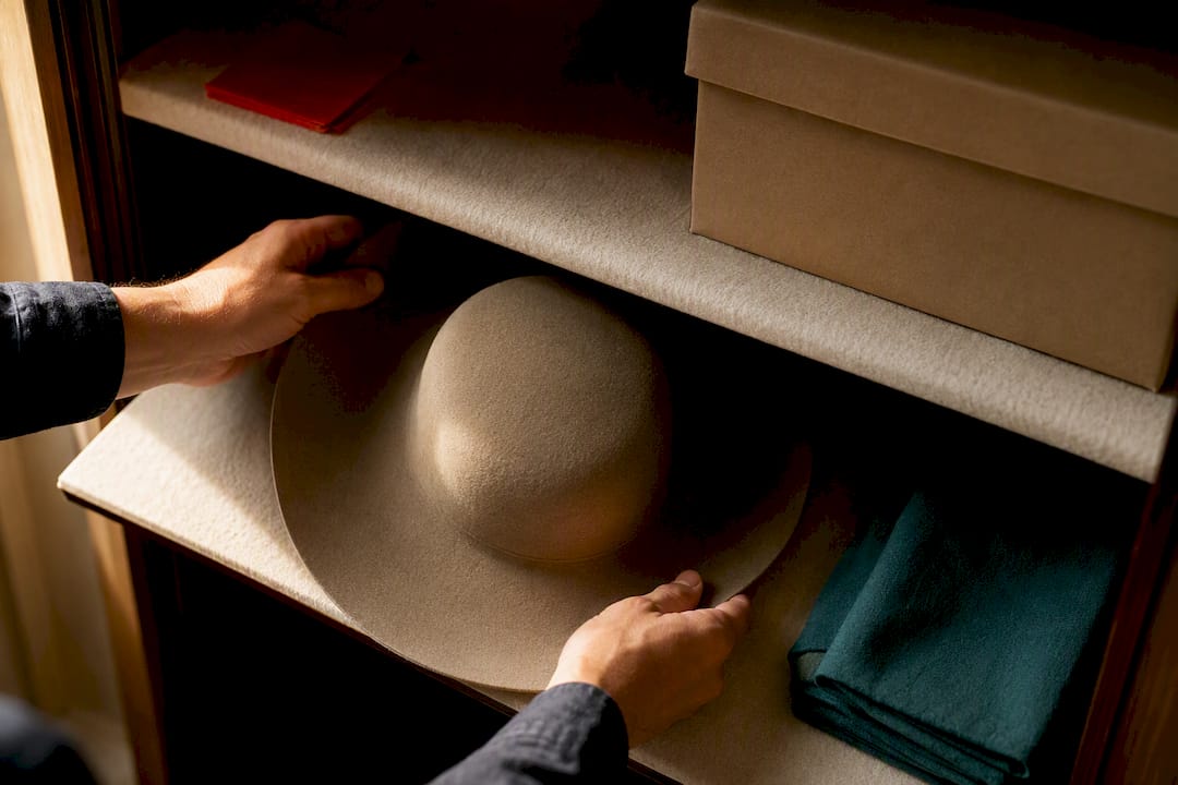 Hat stored crown-down on padded shelf