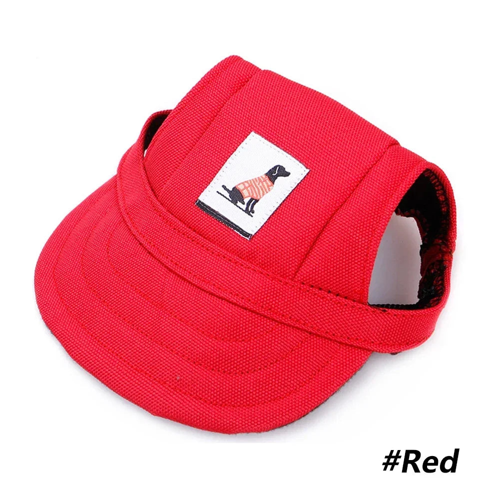Small dog wearing a red baseball cap with chin strap