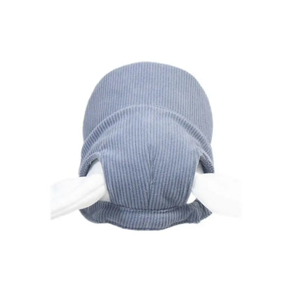 Small dog wearing a khaki corduroy cap
