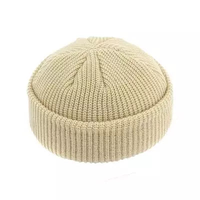 Beige knitted beanie on a white background